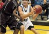 Rogers High’s Brandon Gentz, right, goes to the basket during Saturday’s game against Sherman, Texas, at Rogers High School.