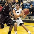 Rogers High’s Brandon Gentz, right, goes to the basket during Saturday’s game against Sherman, Texas...