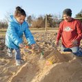 Paul Hernandez of Fayetteville, right, builds a sand castle Sunday with his granddaughter, Attalaya ...