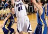 Fayetteville senior Colton Primm, center, takes a shot in the lane as Harrison junior John Colliver, right, reaches to defend during the first half of Saturday’s game at Fayetteville High.