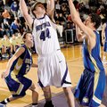Fayetteville senior Colton Primm, center, takes a shot in the lane as Harrison junior John Colliver,...