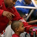 Razorbacks basketball guard Julysses Nobles plays a racing video game Sunday with C.J. Williams, 6, ...
