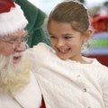 iving her list Hadley Hancock, 8, of Bella Vista visits with Santa Claus on Sunday at the food court...