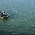 Mike McBride of Winslow fishes Monday for crappie from his boat on Lake Sequoyah in Fayetteville. Bo...