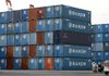 Workers at a wharf in Tokyo are dwarfed by a stack of shipping containers in November.