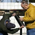 Jim Sperry (left) of Bella Vista and Rex Hickox of Bentonville assemble a stand for a plaque at the ...