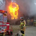 Firefighters battle a blaze Tuesday at 1214 N.E. 10th St. shortly after 2 p.m. in Bentonville. All o...