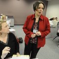 Ashley Daniel, right, data and accountability specialist for Rogers Public Schools, assists Amy Putn...