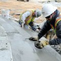 Jeremy Howard, right, and Andres Salas, both with Matrix Concrete Structures of Rogers, finish steps...