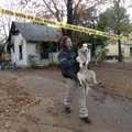 Lindsey Droste, an officer with Conway Animal Welfare, carries a dog that belonged to a mother and t...