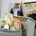 Marge Wolf, right, director of the Northwest Arkansas Food Bank, thanks the Benton County Sheriff’s ...