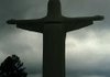 Visitors walk past the Christ of the Ozarks statue as rain clouds roll by Wednesday afternoon at the Great Passion Play grounds in Eureka Springs. Forecasters expect rain showers to change into snow this evening. 