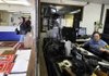 Angie Cope, right, telecommunication supervisor, sits at the dispatch station in the state police headquarters on Monday in Springdale.