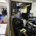 Angie Cope, right, telecommunication supervisor, sits at the dispatch station in the state police he...