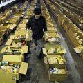Chuck Davis works to stock boxes of food with bags of chicken early Thursday before opening the door...