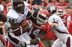Arkansas defender Jerry Franklin brings down Miss. State running back Anthony Dixon during the first quarter at War Memorial Stadium in Little Rock.