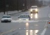 Cars  drive through the bumper-deep standing water on North Hills Blvd in the Dark Hollow area after overnight rains flooded the area in North Little Rock, December 24, 2009.
