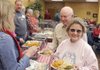 Jim and Rae Oden go through the serving line Friday for a Christmas dinner at the Central United Methodist Church in Rogers.