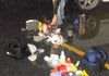 An undercover officer removes contents of a methamphetamine lab from the rear of a sport utility vehicle shortly after 6 p.m. Thursday in the parking lot of the Walmart Supercenter on Walnut Street in Rogers.