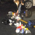 An undercover officer removes contents of a methamphetamine lab from the rear of a sport utility veh...