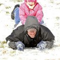 Emily Hammond, 4, hangs on to her father David Hammond for a ride on Christmas day in Rogers on Frid...