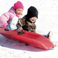 Isabella Anderson, 7, left, and Cameron Sisemore, 6, take a tilted Christmas ride in Rogers. They we...
