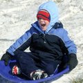 WHITE CHRISTMAS
Christopher McGehee, 4, slides down a hill at J.B. Hunt Park on Friday in Springdal...