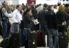 Holiday travelers wait in line Sunday at the Detroit Metropolitan Airport in Romulus, Mich., after the U.S. government tightened airline security.