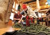 Jackson White, 10, of Springdale, right, helps Cole Fennel, Pack Rat Outdoor Center salesman, untangle climbing rope Jackson purchased Saturday at the longtime Fayetteville business.
