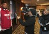 Arkansas tight end D.J. Williams, right, tries to make teammate Ray Dominguez laugh during a television interview by putting rabbit ears over a camera man after the team arrived at the Peabody Hotel in Memphis Sunday in preparation for the Liberty Bowl.