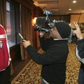 Arkansas tight end D.J. Williams, right, tries to make teammate Ray Dominguez laugh during a televis...