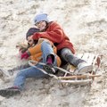 Sarah Behrend-Wilcox, 11, left, and friend Saijal Garza, 9, both of Fayetteville, tumble off a sled ...