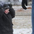 Trey Boyle, 4, of Little Rock braves the cold weather Sunday while playing with his uncle Jason Zean...