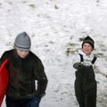 Joe Voss, 7, of Conway throws a snowball at his cousin Abby Pickhardt, 11, of Fayetteville while hea...