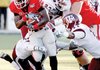 Georgia tailback Washaun Ealey (25) runs past Texas A&M defenders in the first quarter of Monday’s Independence Bowl in Shreveport. Ealey finished with 78 yards rushing in the 44-20 Georgia victory. 