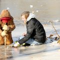 Drew Miller, 13, left, and Taylor Sheppard, 12, dig holes Monday through ice in the 5-inch-deep shal...