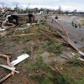 Destroyed houses, overturned vehicles and pine trees litter a street Thursday, Dec. 24, 2009, after ...