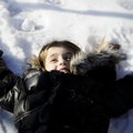Gracie Daniel, 8, of Little Rock makes a snow angel at Murphy Park in Springdale. Daniel and her bro...