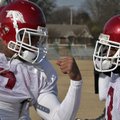 Wide receivers London Crawford, left, and Joe Adams joke around during practice at Rhodes College in...