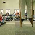 Children watch Janet Hargus, Rogers Historical Museum curator of education, demonstrate how to succe...
