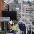 Bob and Jo Holbrook of Santa Fe, N.M., walk south on Block Avenue in Fayetteville on Tuesday. The Fa...