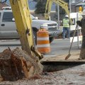 Florentino Rivera stands by to clear away dirt during sewer line work Tuesday at Eighth and Poplar s...