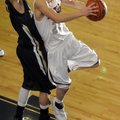 Siloam Springs junior Kyle Teague, right, takes a shot as Shiloh Christian sophomore Taylor Thompson...