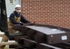 Michael Bisbee, with Multi-Craft Contractors, shifts a section of structural steel as a co-worker uses a loader to stack the pieces Tuesday at Central Junior High School in Springdale. The pieces will be moved by a 60-ton crane for construction of an addition to the school.