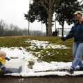 Eric Baggerman of Galveston, Texas, pulls son Daniel, 4, through a patch of snow in a makeshift sled...