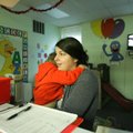 Kayla Norbash, a preschool child care worker at Northwest Arkansas Children’s Shelter, holds one of ...