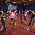 katers dance to “YMCA” on Wednesday on the opening night of the Starlight Skatium in Fayetteville. T...
