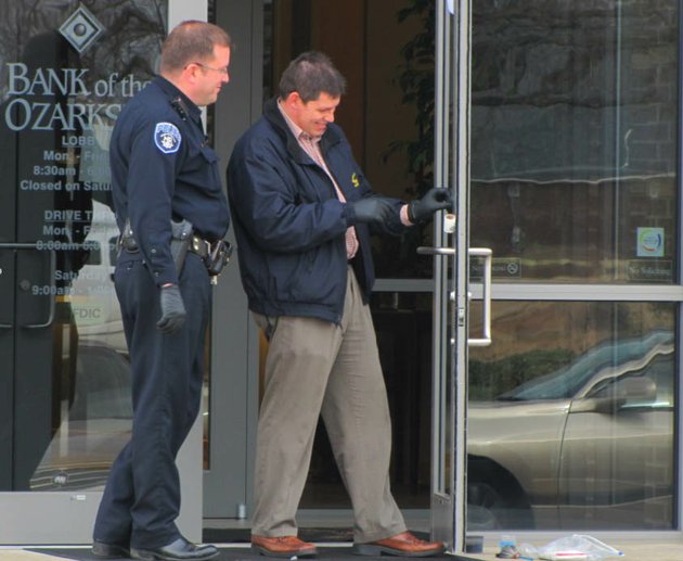 north-little-rock-police-officers-dust-for-fingerprints-on-the-front-door-of-a-bank-of-the-ozarks-after-a-robbery-this-morning