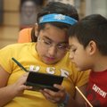 Time for a game Melissa Gutierrez, 10, and her brother Eduardo, 3, play a video game Wednesday in th...