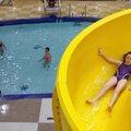 Taking the plunge Faith Bratcher, 10, of Holton, Kan., eases down the water slide Wednesday at the J...